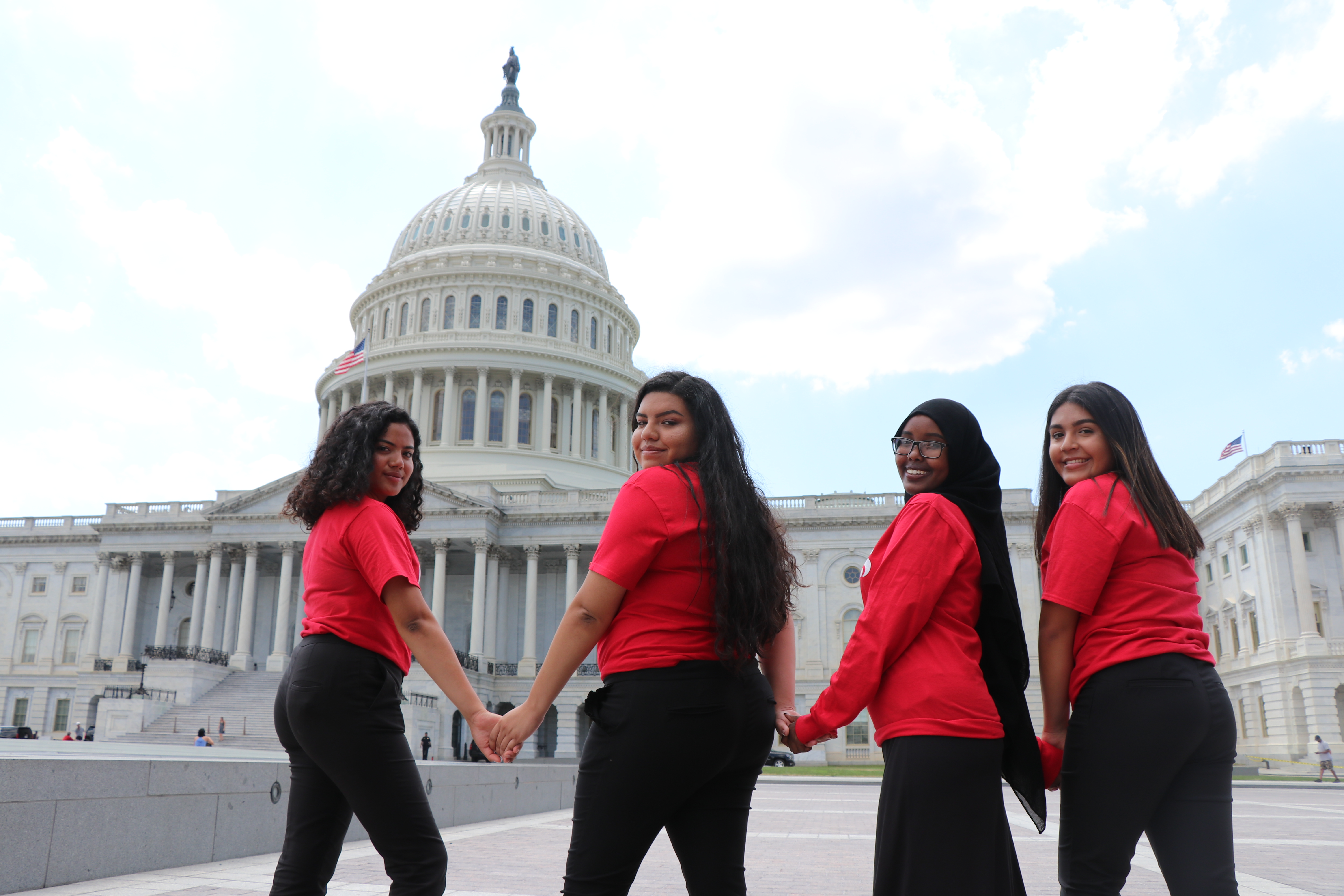 4 young women standing in front of the capital in Washington DC